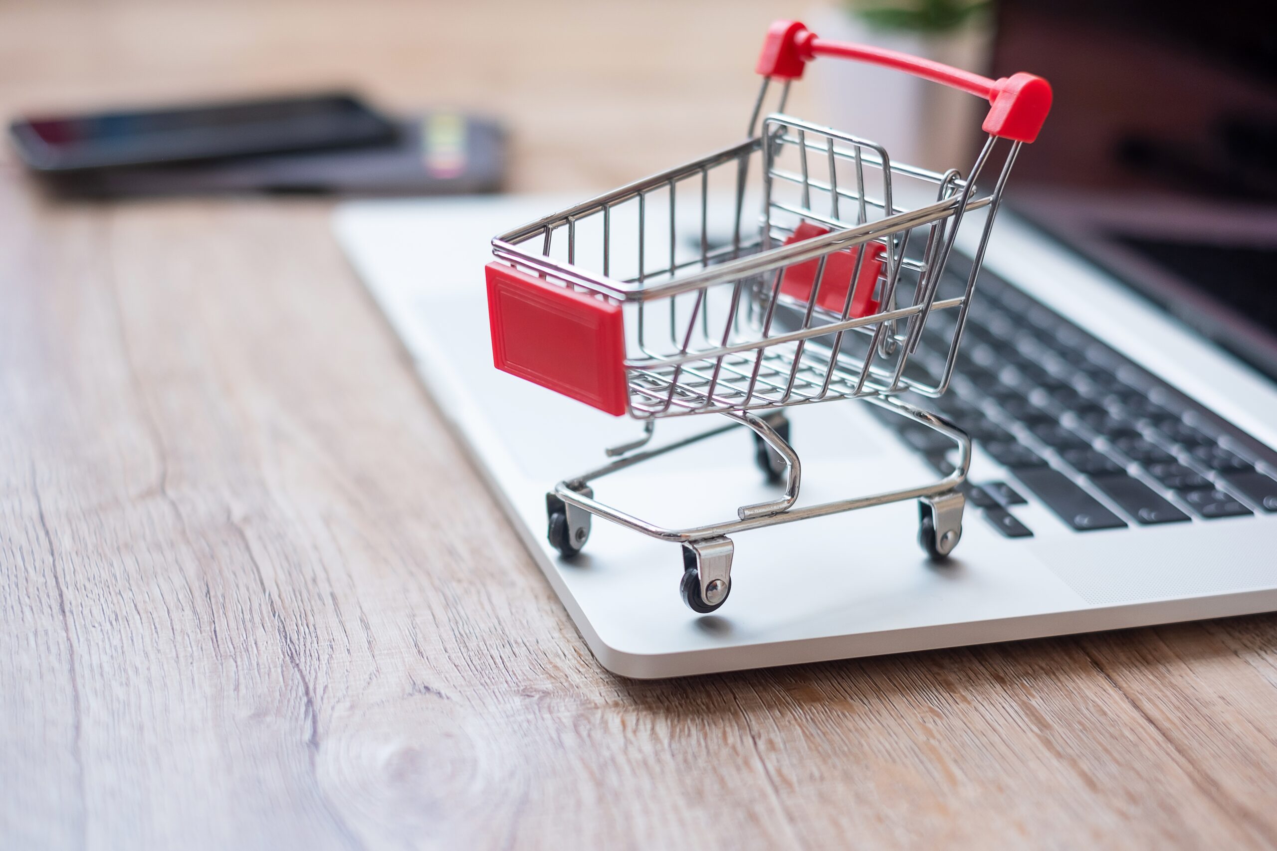 Shopping cart on laptop at home office. business, e-business, te
